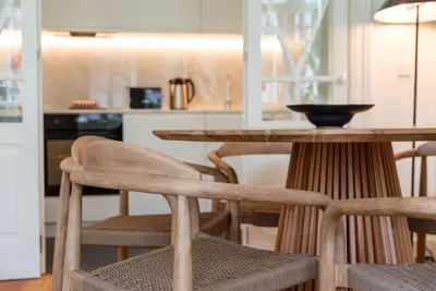 a table and chairs in a kitchen with a counter at Almada 559 - Ortigão Residence by Lisbeyond in Porto
