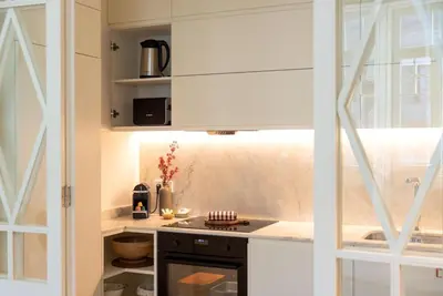 a kitchen with white cabinets and a stove top oven at Almada 559 - Ortigão Residence by Lisbeyond in Porto