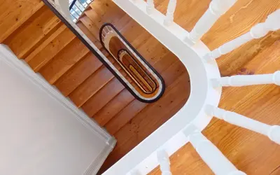 an overhead view of a spiral staircase with wooden floors at Best Guest Porto Hostel in Porto
