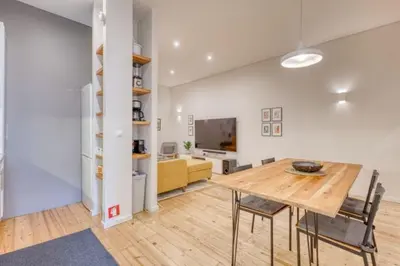 a kitchen and dining room with a table and chairs at OPORTO GUEST Alegria126 in Porto