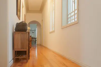 an empty hallway with white walls and wooden floors at Carolina M Apartment in front of Metro in Porto