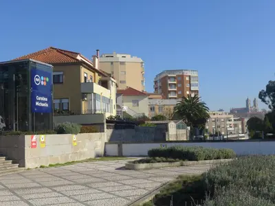 a building with a sign on the side of a street at Carolina M Apartment in front of Metro in Porto