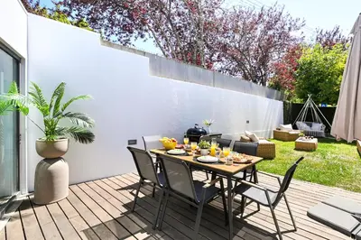 a patio with a table and chairs on a deck at Luxury House by ON Apartments in Porto