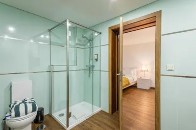 a black tufted stool in a room with a picture at Luxury House by ON Apartments in Porto