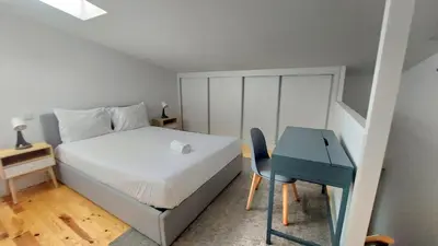a bedroom with a large white bed with white sheets and pillows at Gaia Apartments by the Wine Cellars in Vila Nova de Gaia