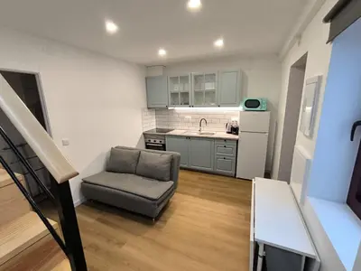 a small kitchen with a chair and a sink at Gaia Apartments by the Wine Cellars in Vila Nova de Gaia