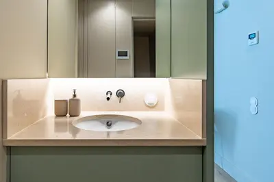 a bathroom counter with a sink and a mirror at Bonjardim Suites in Porto