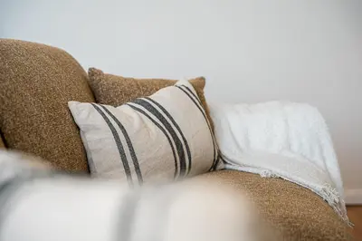 a couch with two pillows on it at GuestReady - Fantastic house in the city center in Porto