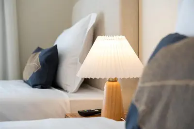 a lamp on a table next to a bed at GuestReady - Fantastic house in the city center in Porto
