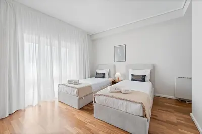 a white room with two beds and a couch at GuestReady - Fantastic house in the city center in Porto
