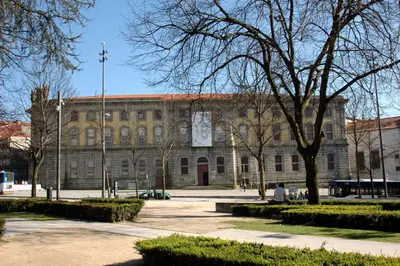 a large building with a clock on the front of it at Almond Biscuit Porto Historic Center in Porto