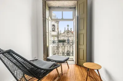 an empty room with a chair and a window at Almond Biscuit Porto Historic Center in Porto
