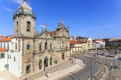an old building with a clock tower on a street at Almond Biscuit Porto Historic Center in Porto