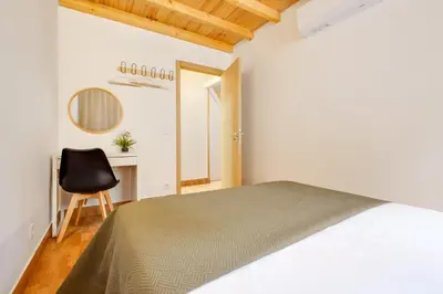 a bedroom with a bed and a chair and a desk at Porto Covelo Park Apartment in Porto