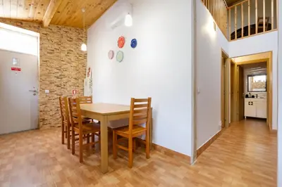 a dining room with a wooden table and chairs at Porto Covelo Park Apartment in Porto