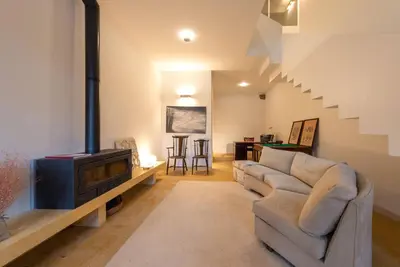 a living room with a couch and a staircase at Riverfront Heritage House in Vila Nova de Gaia