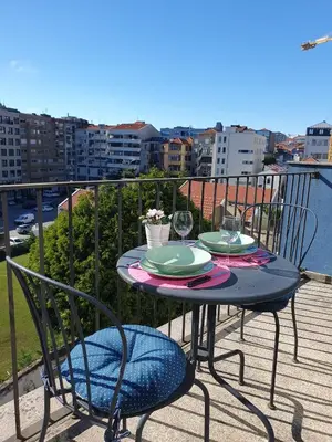 a table and chairs on a balcony with a view at Bonjardim Bright Studio in Porto