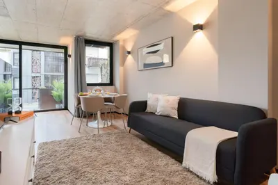 a living room with a couch and a table at Modern & Cozy Flats with Terrace by HostWise in Porto