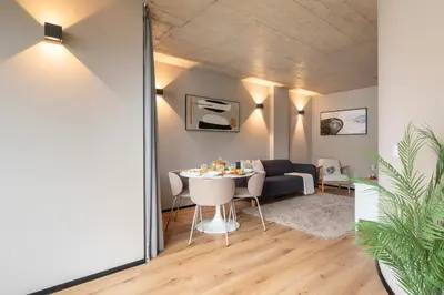 a living room with a couch and a table at Modern & Cozy Flats with Terrace by HostWise in Porto