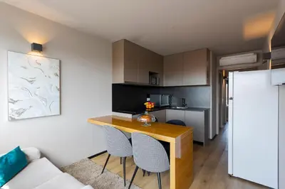 a bathroom with a white toilet and a sink at Modern & Cozy Flats with Terrace by HostWise in Porto