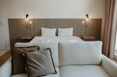 a hotel room with a bed and two chairs at Bolhão Downtown in Porto