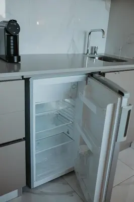 an empty refrigerator with a sink and a counter at Bolhão Downtown in Porto
