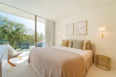 a bedroom with a bed and a large window at The Luminous by Lovely Memories - Pool Access in Porto