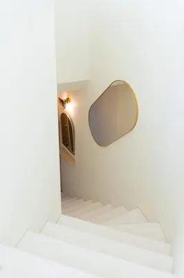 a mirror on the wall above the stairs in a room at The Luminous by Lovely Memories - Pool Access in Porto