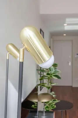 a lamp in a room with a table and a plant at Liiiving in Porto - Luxury Gallery Apartment I in Porto
