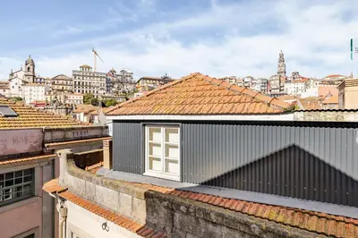 a living room with a couch and a mirror at Charming & Sunny Stay in Historic Porto in Porto