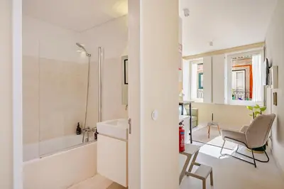 a bedroom with a white bed with two green pillows at Charming & Sunny Stay in Historic Porto in Porto