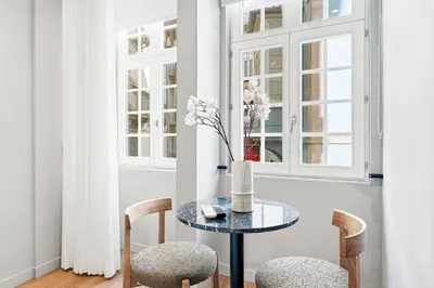 a dining room with a glass table and chairs at GuestReady - The Cats Studios in Porto