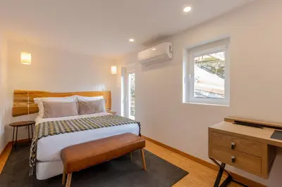 a bedroom with a bed and a window and a television at YOUROPO - Cosy in Porto