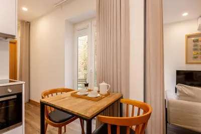 a dining room with a wooden table and chairs at YOUROPO - Cosy in Porto