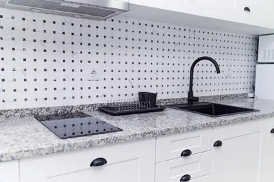 a white kitchen with a microwave on top of a refrigerator at Refúgio do Pilar in Vila Nova de Gaia