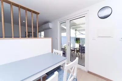 a dining room with a table and chairs and a balcony at Refúgio do Pilar in Vila Nova de Gaia