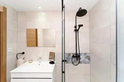 a bathroom with a shower and a white sink at Refúgio do Pilar in Vila Nova de Gaia