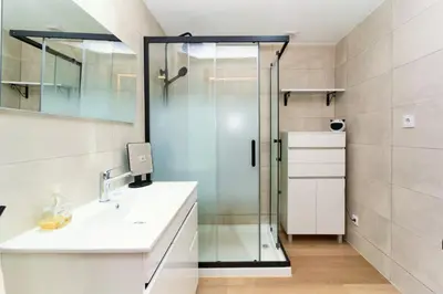 a bathroom with a glass shower and a sink at Refúgio do Pilar in Vila Nova de Gaia