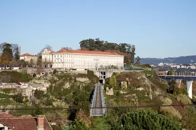 a large white building on a hill with a bridge at Refúgio do Pilar in Vila Nova de Gaia