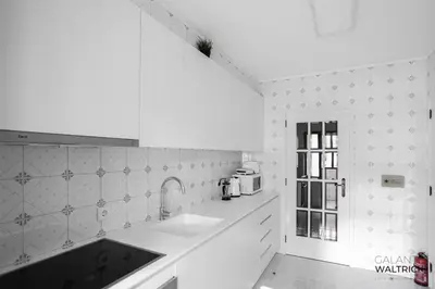 a white kitchen with a sink and a microwave at 2Bedroom Flat - Families, remote work, downtown - Private Garage in Porto