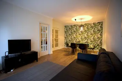 a living room with a couch and a flat screen tv at 2Bedroom Flat - Families, remote work, downtown - Private Garage in Porto