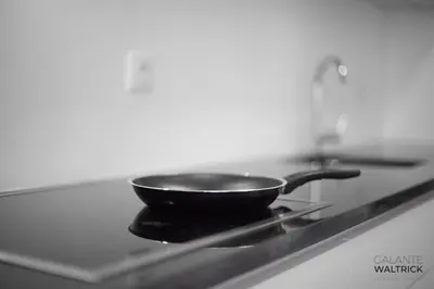 a frying pan sitting on top of a stove at Quiet 3BR Flat - City Center - Warm and Bright - Remote Work in Porto