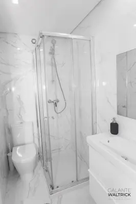 a bathroom with a shower and a toilet and a sink at Quiet 3BR Flat - City Center - Warm and Bright - Remote Work in Porto
