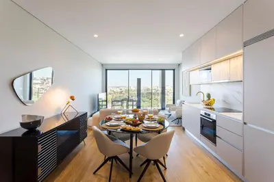 a kitchen and living room with a table and chairs at Modern Porto Retreat by HostWise in Vila Nova de Gaia