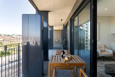 a room with a table and a balcony at Modern Porto Retreat by HostWise in Vila Nova de Gaia