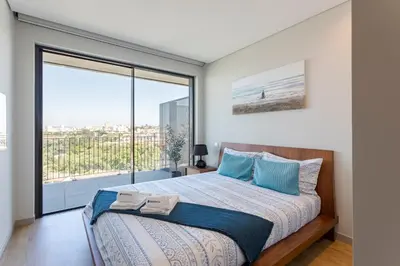 a bedroom with a bed and a large window at Modern Porto Retreat by HostWise in Vila Nova de Gaia