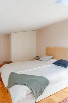 an attic bedroom with two beds and a window at Kleine's House in Porto - Mezzanine Boavista in Porto