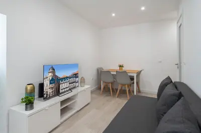 a living room with a tv and a table at Authentic Porto Home by HostWise in Porto