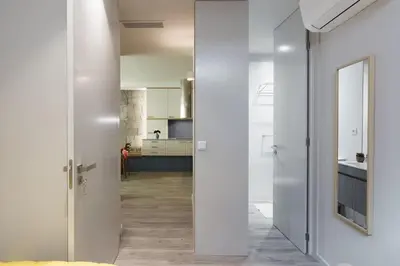 a hallway with white walls and a kitchen at Charming Flat - Garage by Host Wise in Porto
