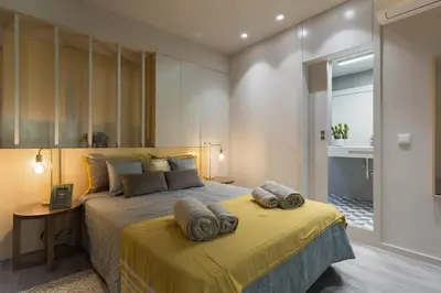a bedroom with a bed with two towels on it at Charming Flat - Garage by Host Wise in Porto